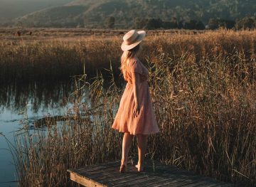 blonde standing by lake